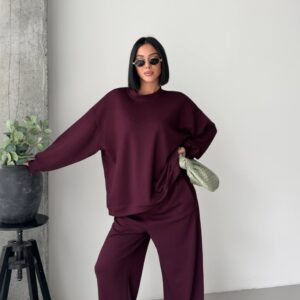 Burgundy crewneck sweatshirt with dropped shoulders and roomy sleeves paired with matching wide-leg pants.