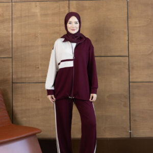 Front view of a burgundy zip jacket with a cream sleeve and matching striped trousers.
