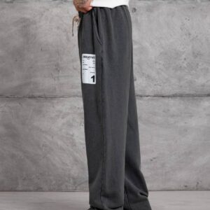 Side view of charcoal wide-leg sweatpants with a drawstring waist and white rectangular thigh patch. available for wholesale in Turkey.
