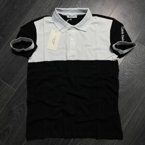 Flat lay of a black polo with a white chest panel, contrast collar, and short sleeves. available for wholesale in Turkey.