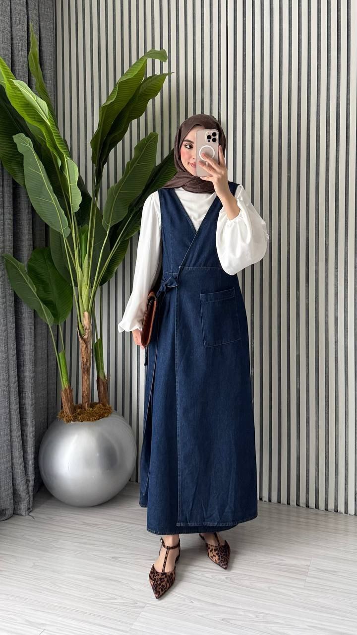 dark-denim-wrap-front-7361 Front view of a dark blue sleeveless denim dress with a wrap bodice, tie waist, and long skirt.