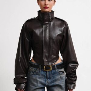 Front view of a dark cropped jacket with a raised collar, shoulder tabs, and voluminous sleeves.