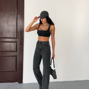 Three-quarter front view showing the fitted square-neck crop top and long, loose charcoal jeans.