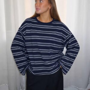 Front view of a navy sweatshirt with thin white horizontal stripes, a crew neck, and loose long sleeves. available for wholesale in Turkey.