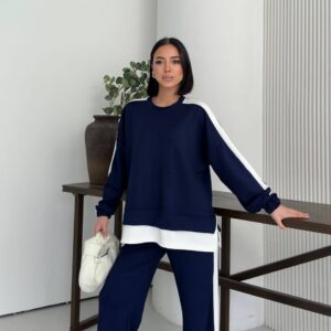Front view of a navy sweatshirt with white shoulder stripes and layered hem, paired with matching wide-leg pants.