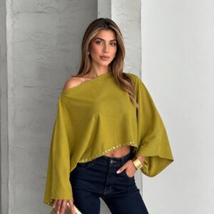 Olive cropped poncho top with an asymmetrical neckline, draped sleeves, and small silver studs along the hem available for wholesale in Turkey.