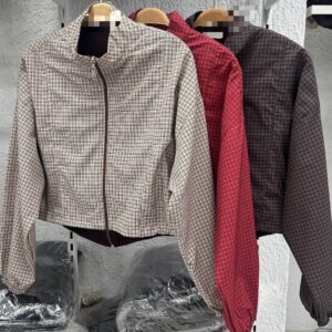 Three cropped plaid jackets on hangers in cream, red, and charcoal with front zippers.