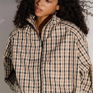 Close view of a beige, black, and brown plaid jacket with a raised collar and black front zipper. available for wholesale in Turkey.