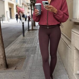 Model wearing a red plaid cropped jacket with a front zipper and adjustable hem. available for wholesale in Turkey.