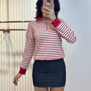 White long-sleeve top with red horizontal stripes, a short front zipper, and bright red collar and cuffs.