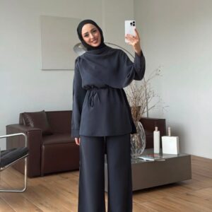 Front view of a slate blue tunic with a draped neckline, waist ties, and matching wide-leg trousers.