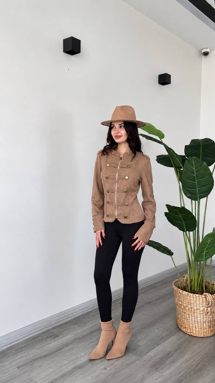 taupe-jacket-full-look-6318 Full outfit showing a taupe jacket with a front zipper, buttoned trim, and long sleeves over black leggings.