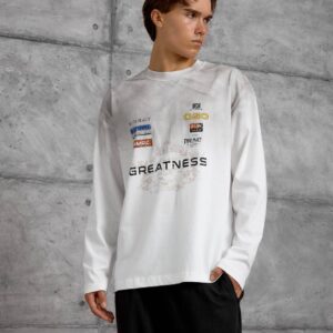 Front view of a white shirt with a cluster of small colored graphics above a large dark chest design.